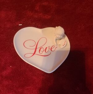 Heart-shaped trinket dish with 'Love' script. Features a small angel figurine.